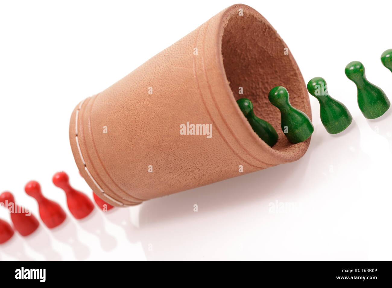 Il rosso e il verde figure in legno in esecuzione mediante un agitatore. La trasformazione, modificare e metamorfosi del concetto. Foto Stock