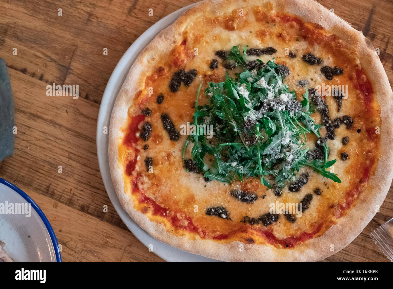 Pizza in pietra con provolone, tartufata e rucola Foto Stock