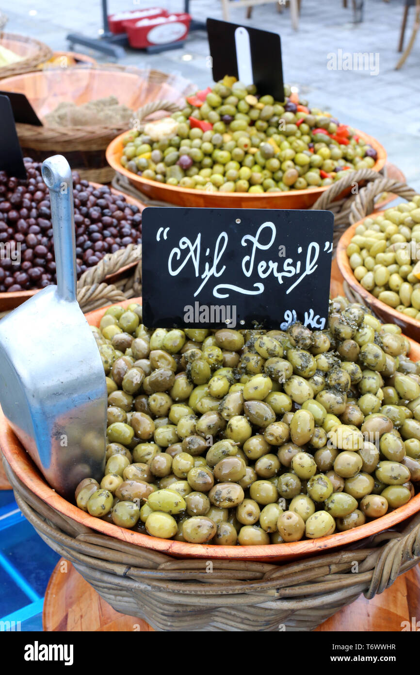 Vente d'olive vertes, ail et persil, sur onu marché locale. Foto Stock
