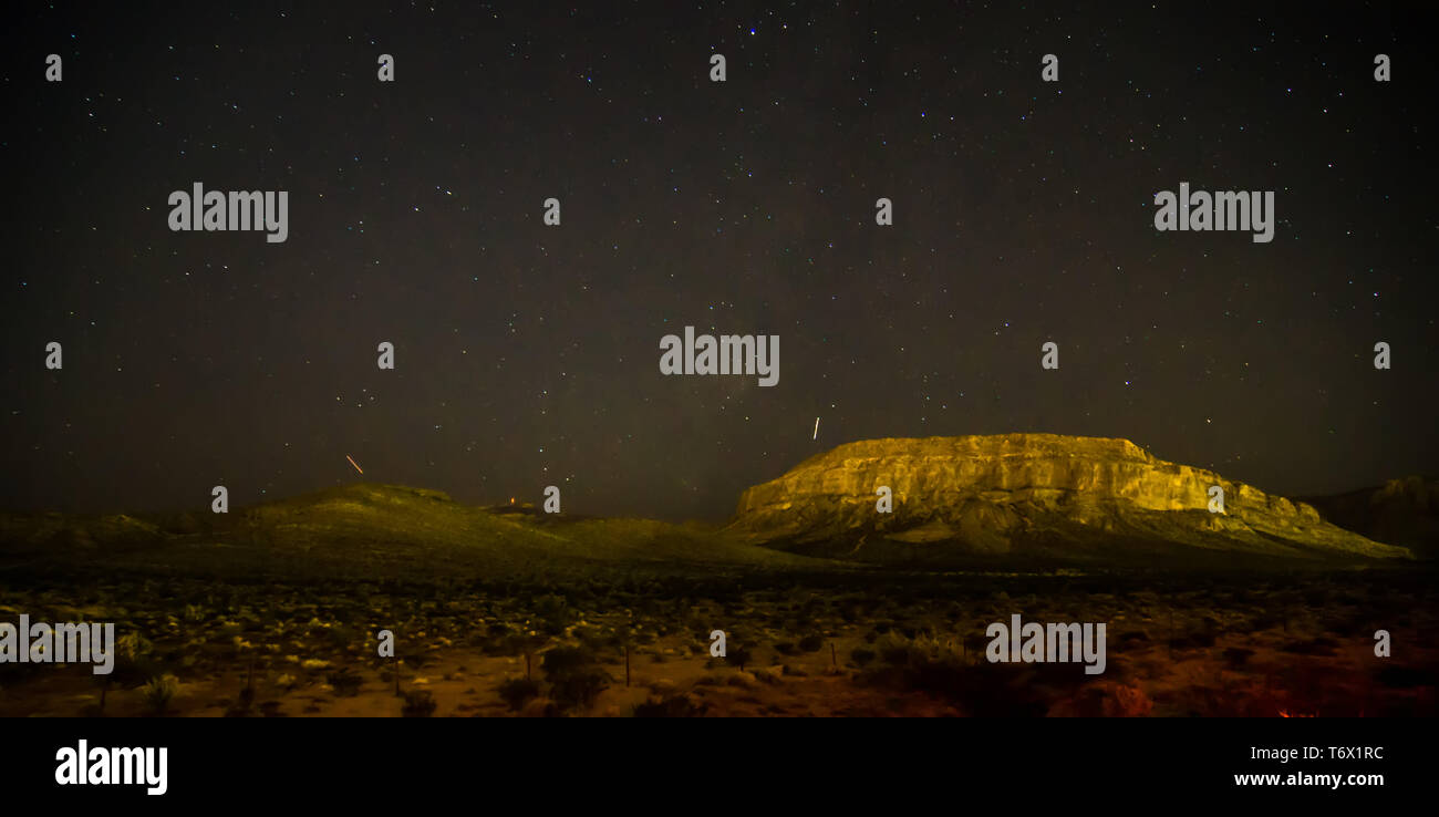 La notte e il cielo scuro oltre il parco nazionale della Valle della Morte Foto Stock