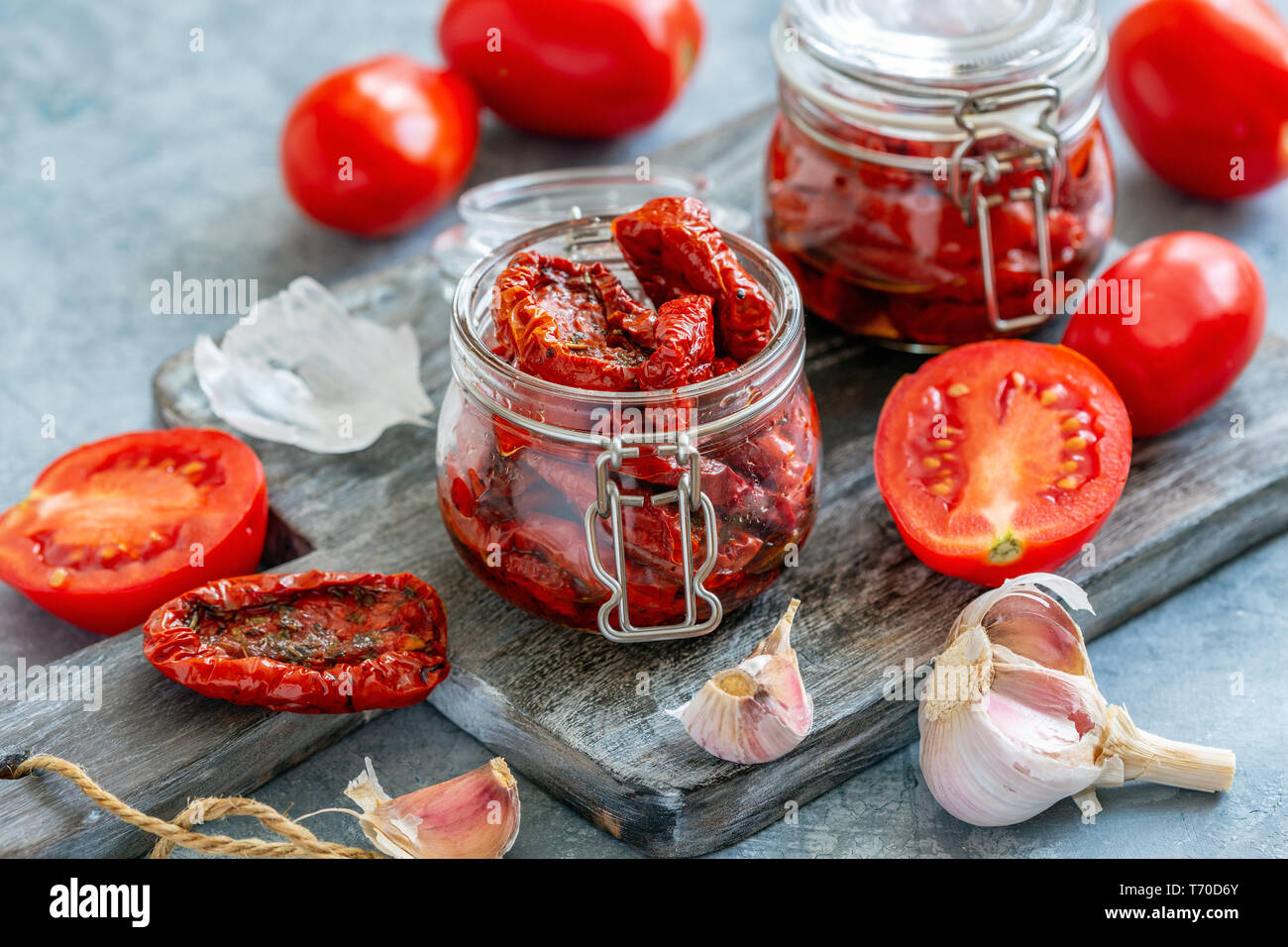 Pomodori secchi con erbe e olio di oliva in vaso. Foto Stock