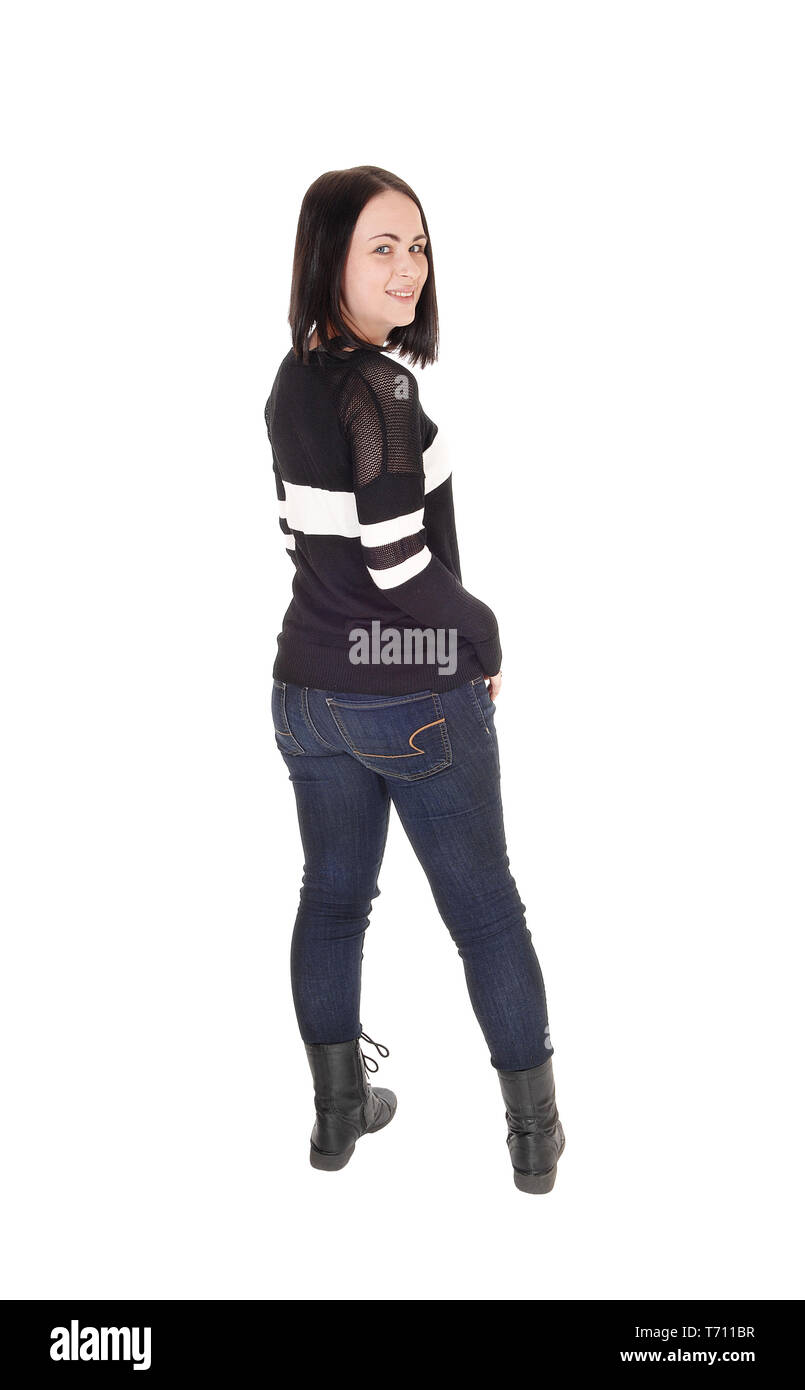 Piuttosto giovane donna in piedi in jeans dal retro Foto Stock