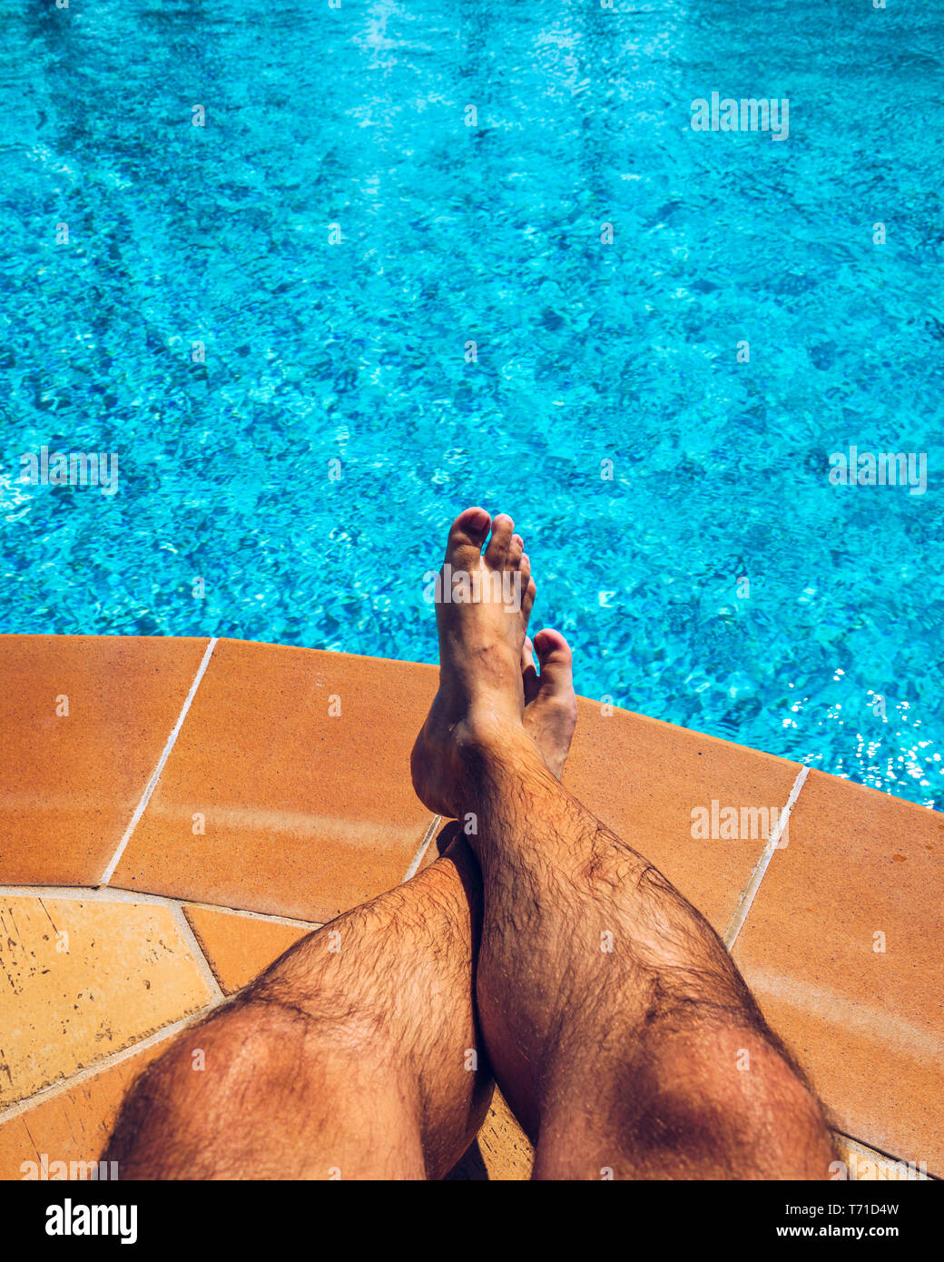 Relax presso la piscina. L'uomo rilassarsi vicino alla piscina. L'uomo godendo della calda estate in piscina. Prendere il sole in piscina, mans Foto Stock