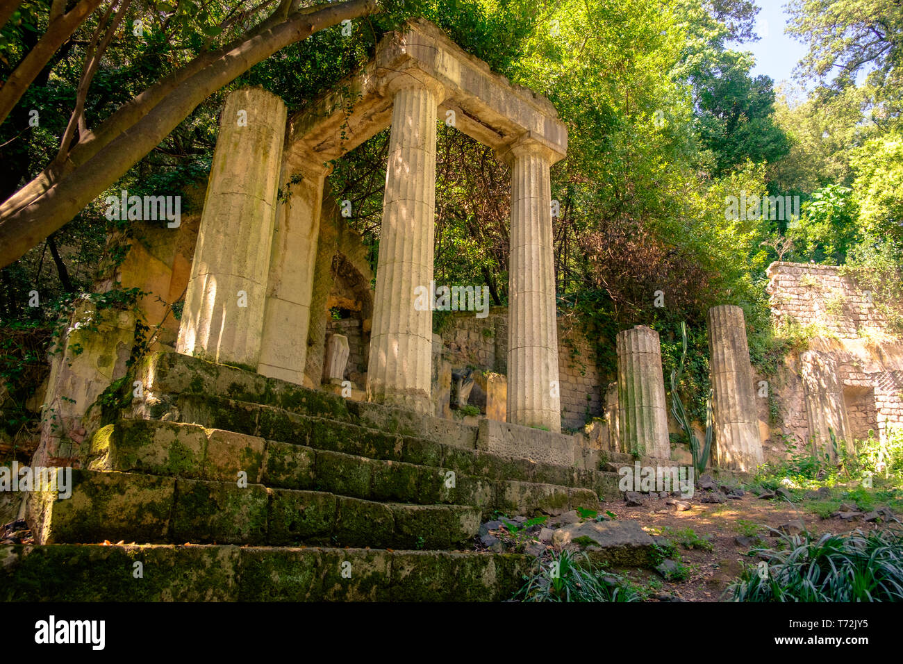 Nel giardino inglese di "Reggia di Caserta', è possibile vedere alcuni falsi ruderi. Questo è un tempio rovina che è apparentemente perso nella giungla. Foto Stock