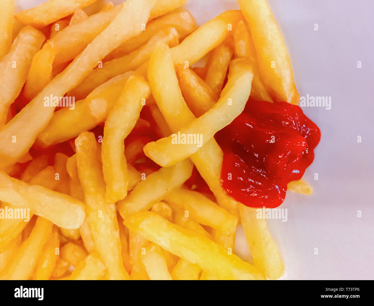 Vista ravvicinata di patate fritte con ketchup salsa. Il cibo spazzatura e uno stile di vita poco salutare Foto Stock