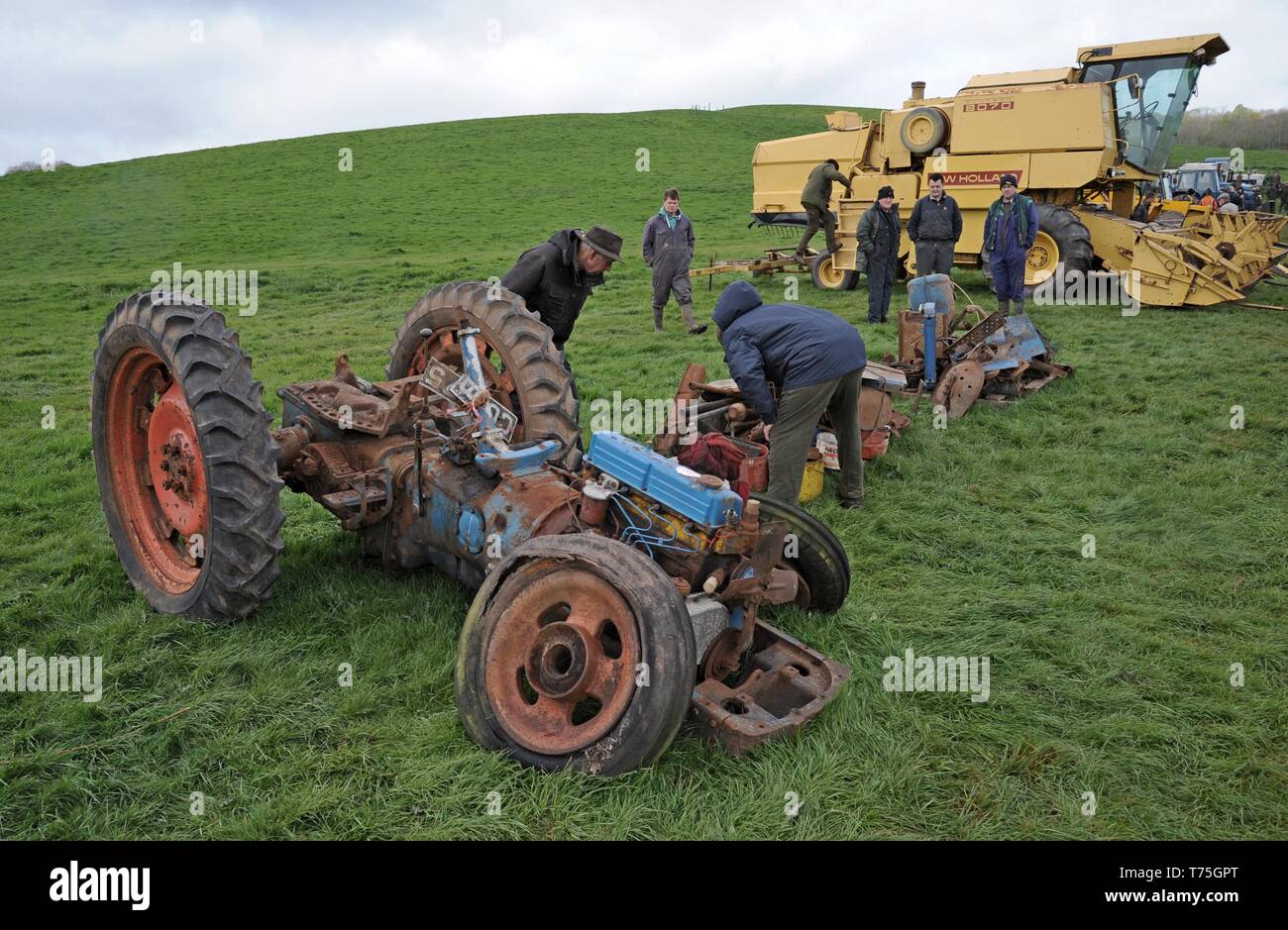 Persone esaminando una mietitrebbia in vendita presso un'azienda asta superiore Fattoria Venn, Herefordshire Foto Stock
