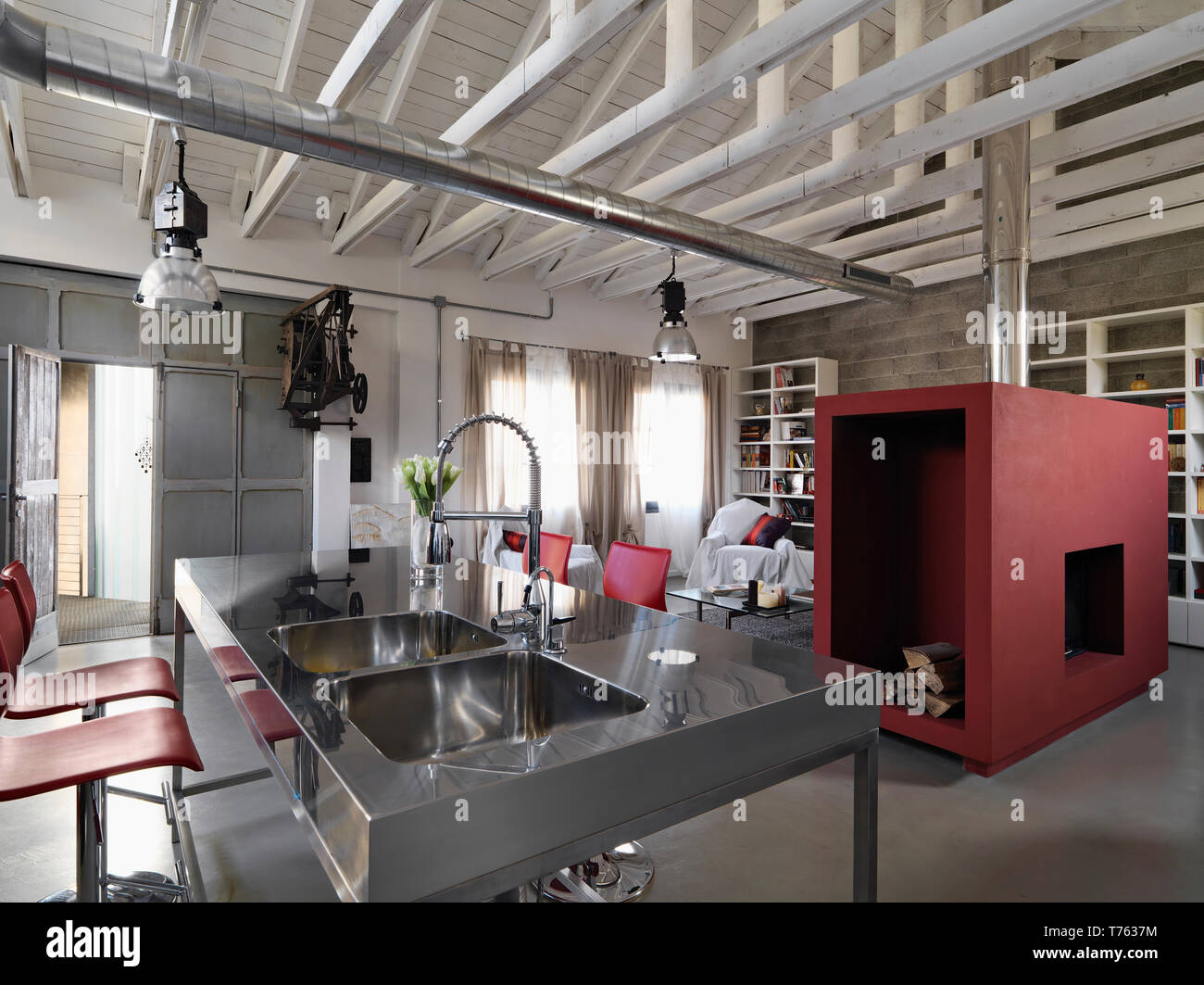 Scatti di interni di un moderno attico in primo piano la cucina in acciaio isola con lavandini in acciaio integrato Foto Stock