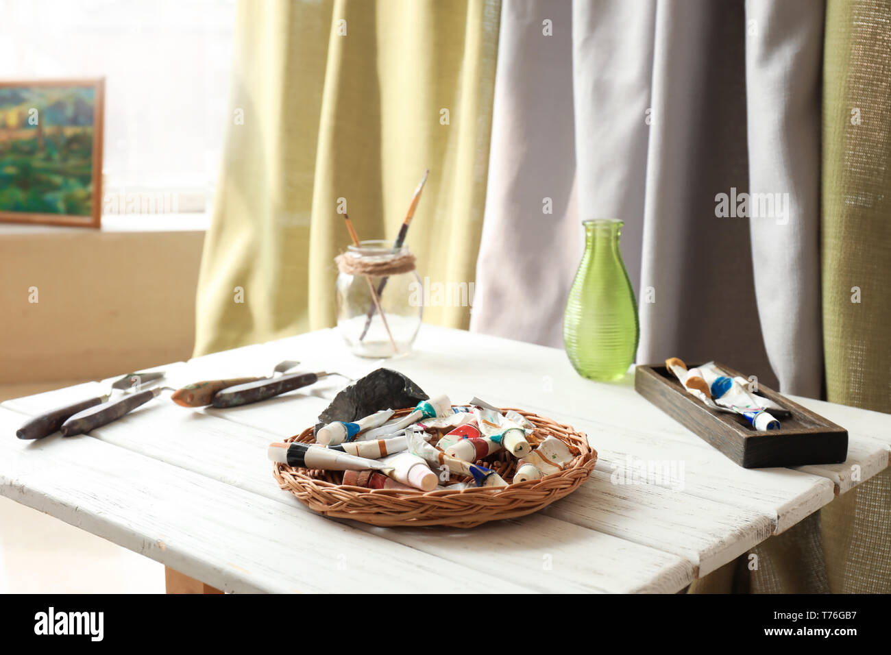 Provette con vernici su tavola in studio dell'artista Foto Stock