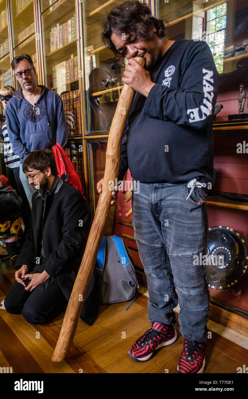 Londra, Regno Unito. Il 4 maggio 2019. Indigeni attivista australiano Rodney Kelly inizia il suo parlare dalla riproduzione di un didgeridoo nella parte anteriore del riparo Gweagal nel tour non ufficiale del British Museum da attivisti "BP o non BP?' Samir Eskanda ha parlato su oggetti da '" biblica scavi in Palestina, Yasmin Younis sui recenti saccheggi da parte di Iraq e Petros Papadopoulos su i marmi del Partenone. Credito: Peter Marshall / Alamy Live News Foto Stock