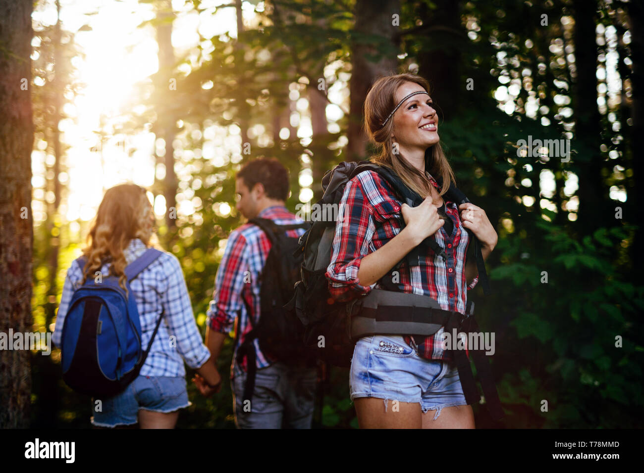 Gruppo di persone escursioni nella foresta e sorridente Foto Stock