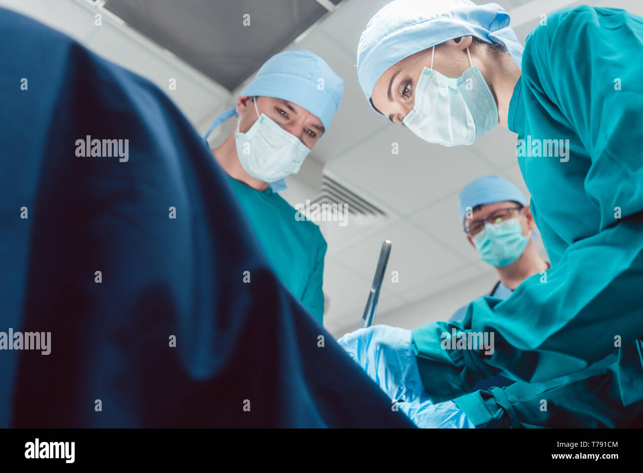 Il team di chirurghi nella camera operativa durante la chirurgia Foto Stock