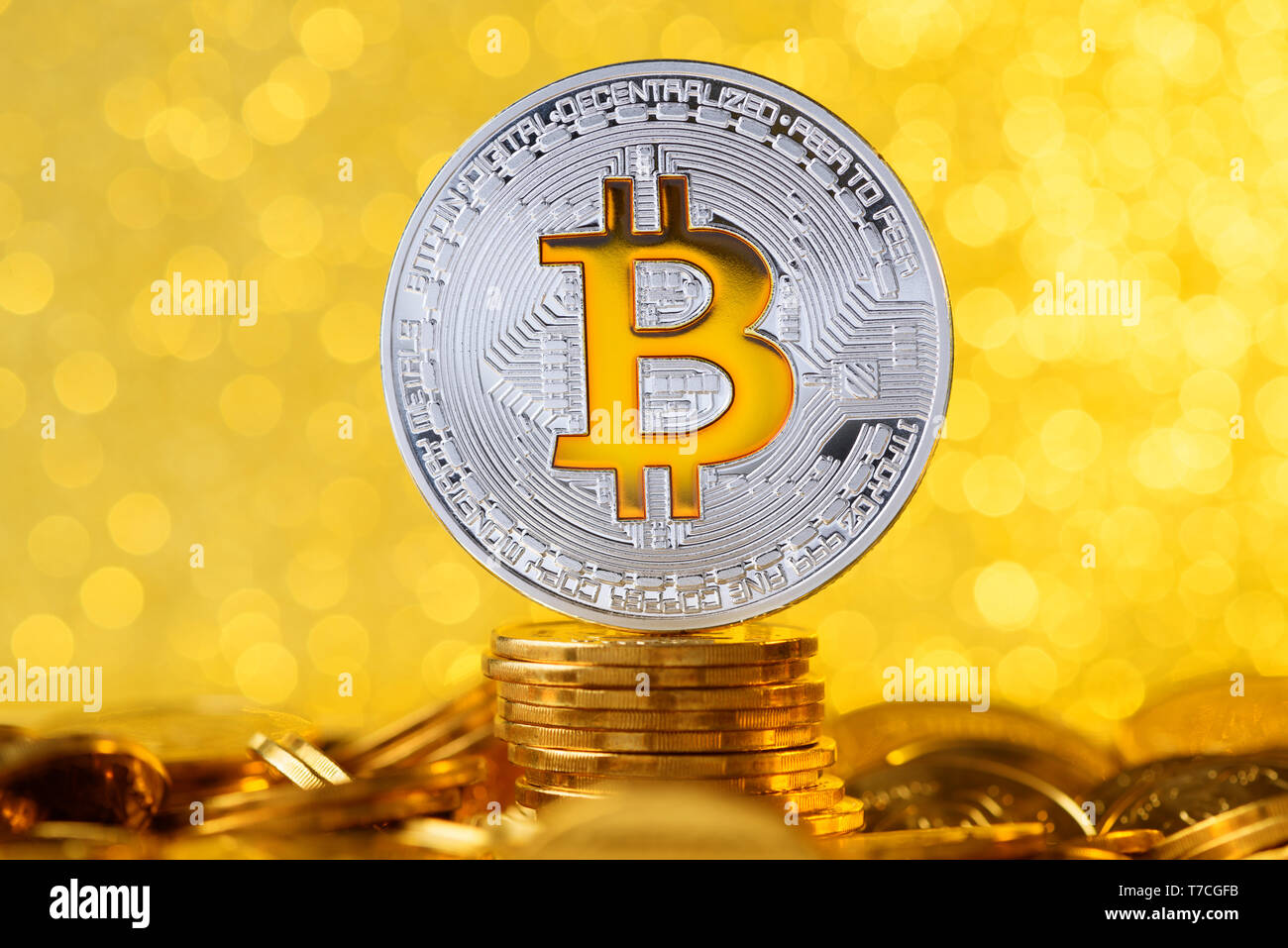 Bitcoin con simbolo di bit sulla parte superiore della moneta in oro in uno stack con shiny golden lights sfondo bokeh di fondo Foto Stock