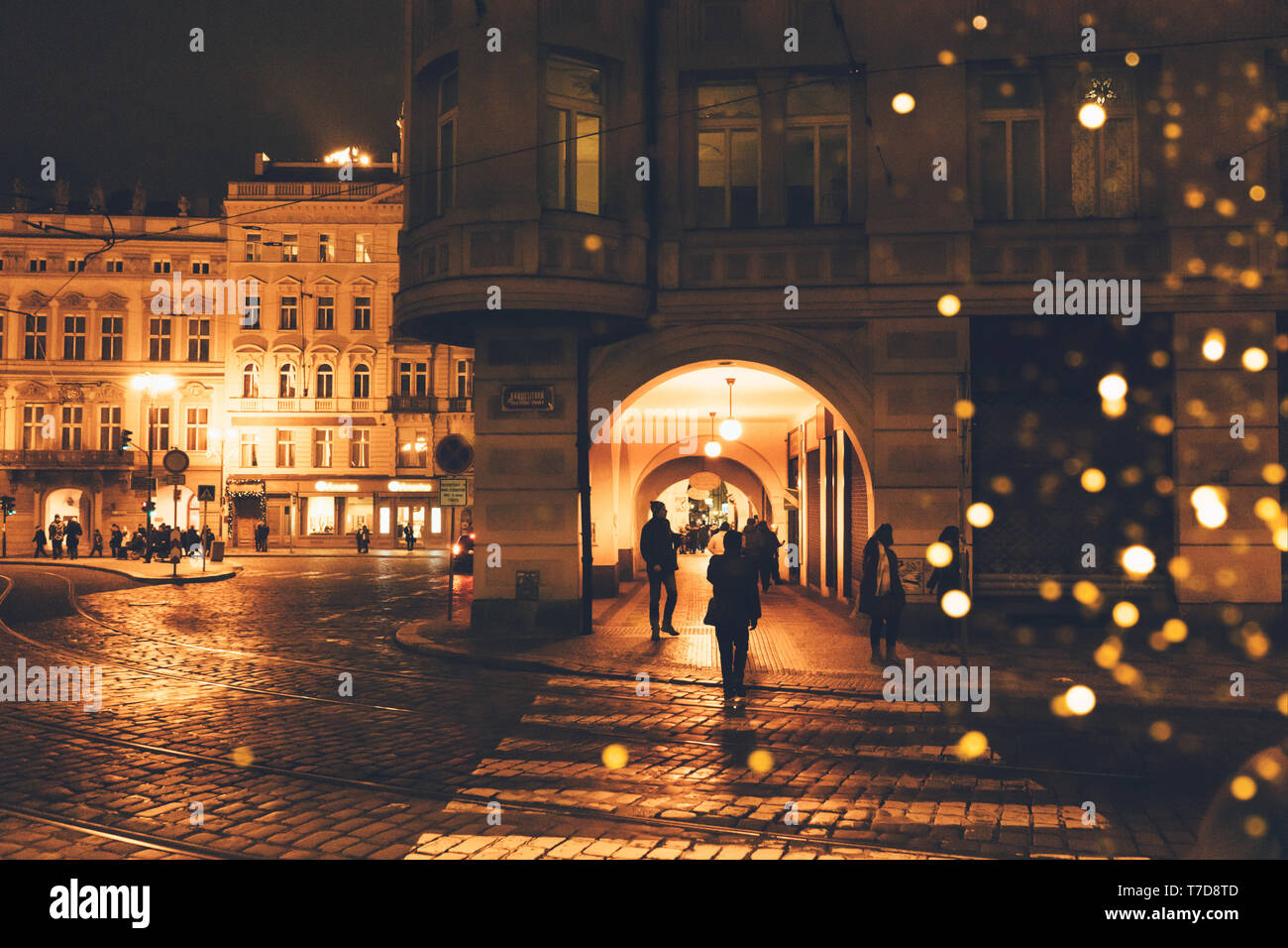 Repubblica Ceca, Praga - Dicembre 24, 2018: strada notte in una città europea con bokeh da lanterne di Natale, sagome di persone e facciate di b Foto Stock