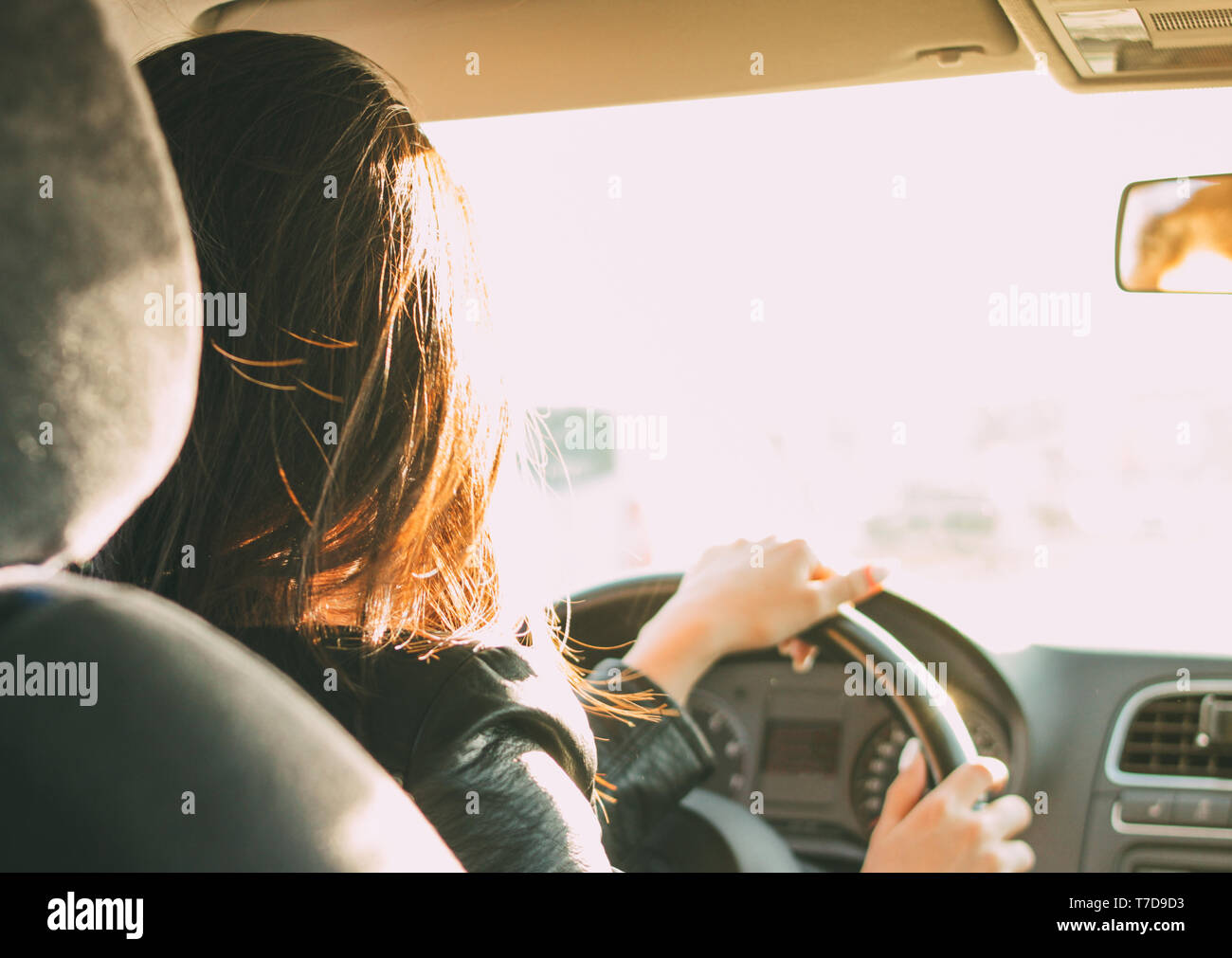 Giovani brunette capelli lunghi donna alla guida di automobili Foto Stock