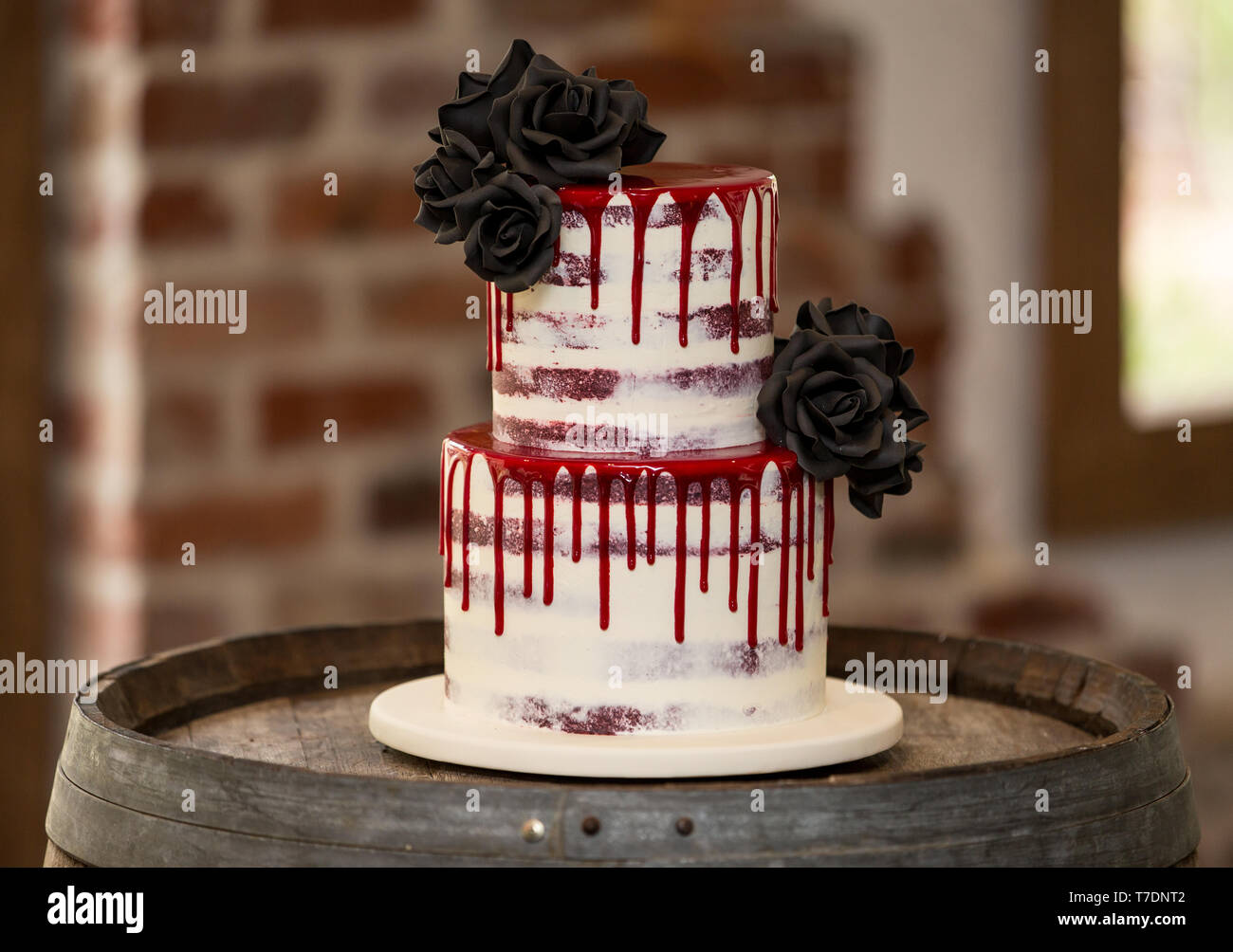 Moderna torta di nozze con fiori di colore nero e rosso la glassa Foto Stock