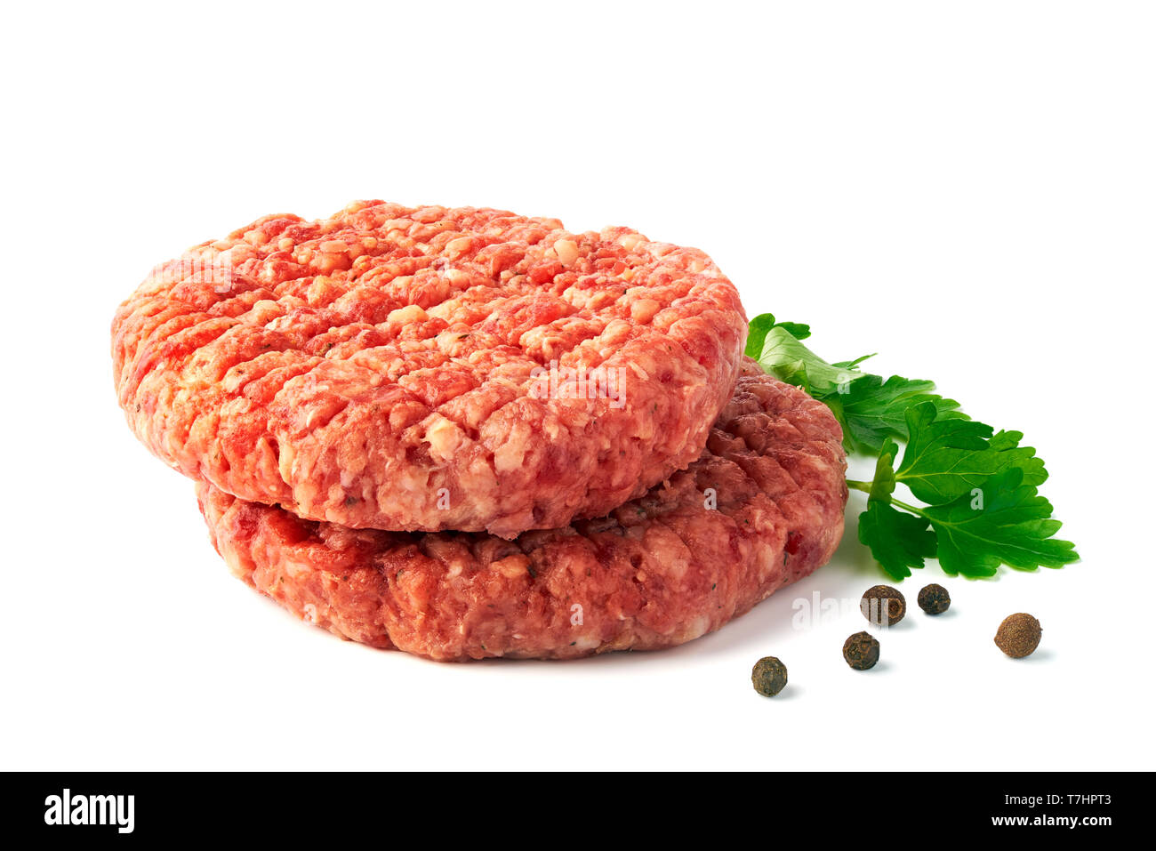Due materie polpette di carne di manzo con spezie su sfondo bianco Foto Stock