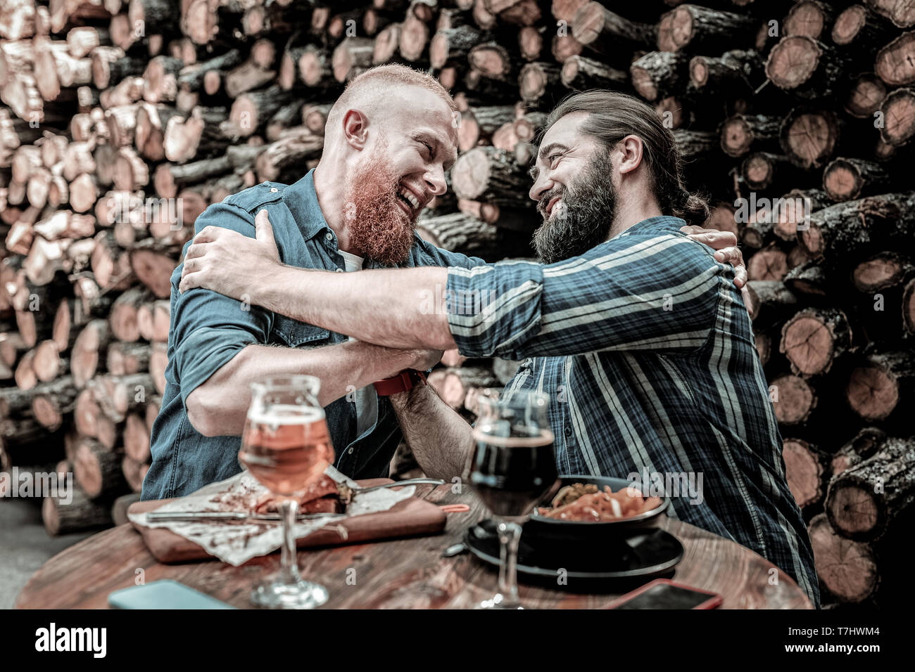 Due uomini sorridenti dando a ogni altro un cordiale abbraccio. Foto Stock