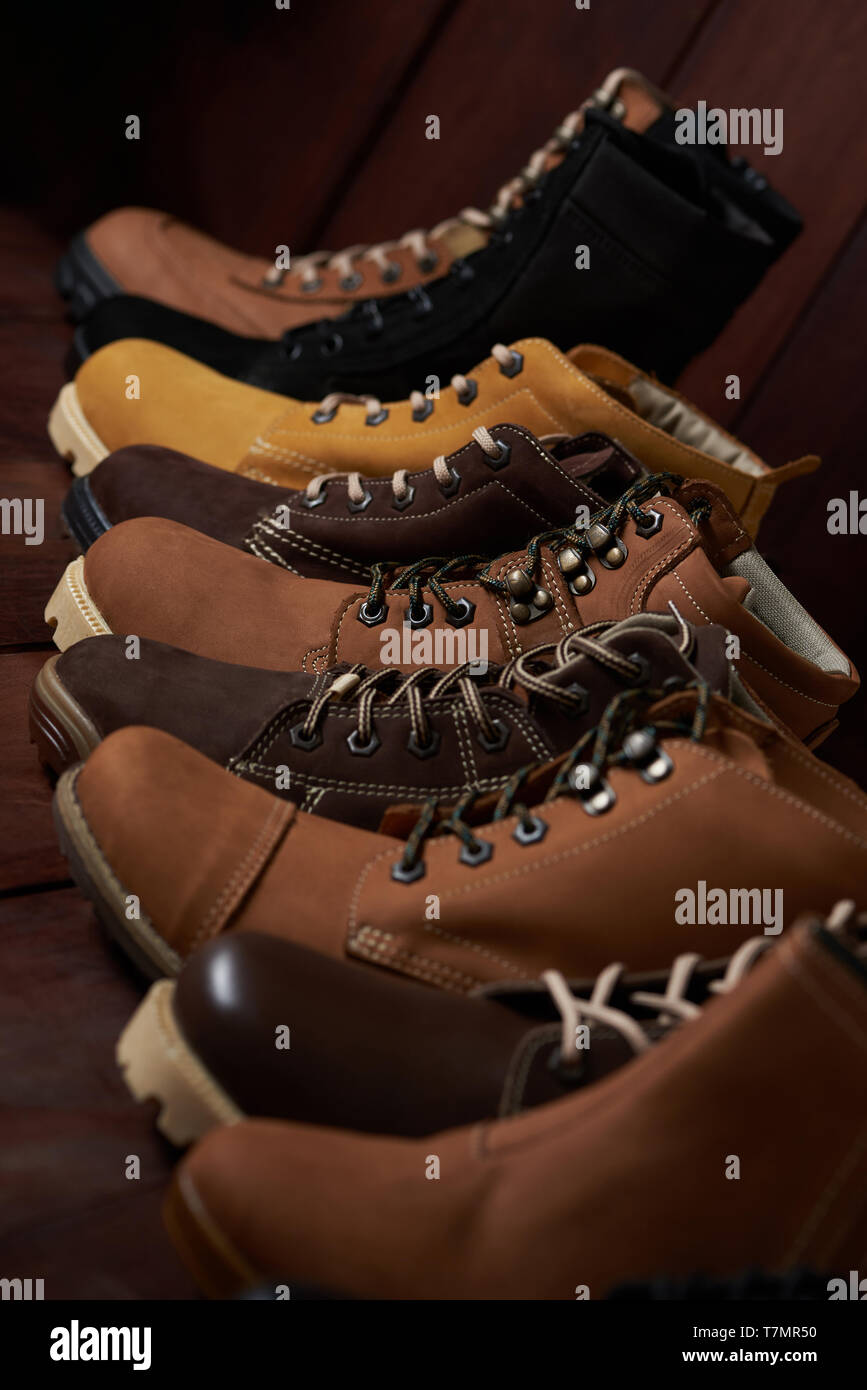 La linea di calzature in pelle stand su sfondo di legno Foto Stock