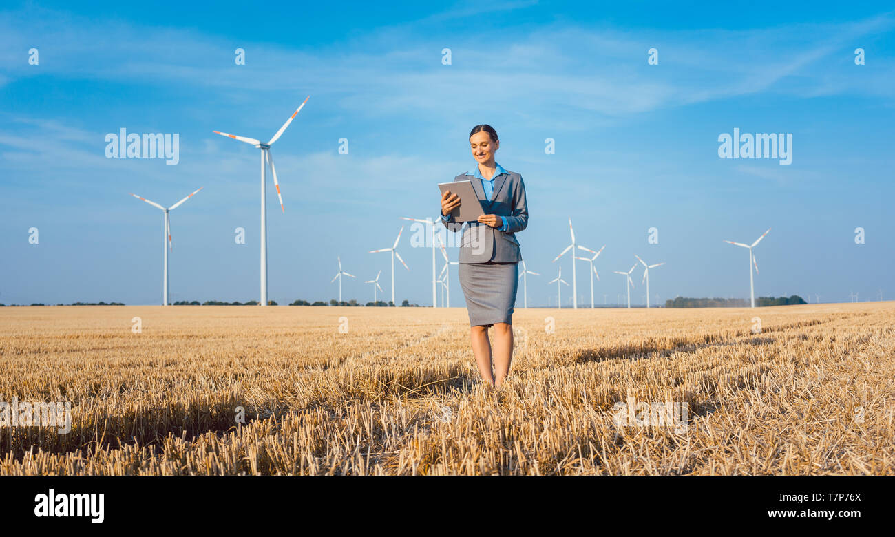 Le donne mettere soldi in un investimento etico delle turbine eoliche Foto Stock