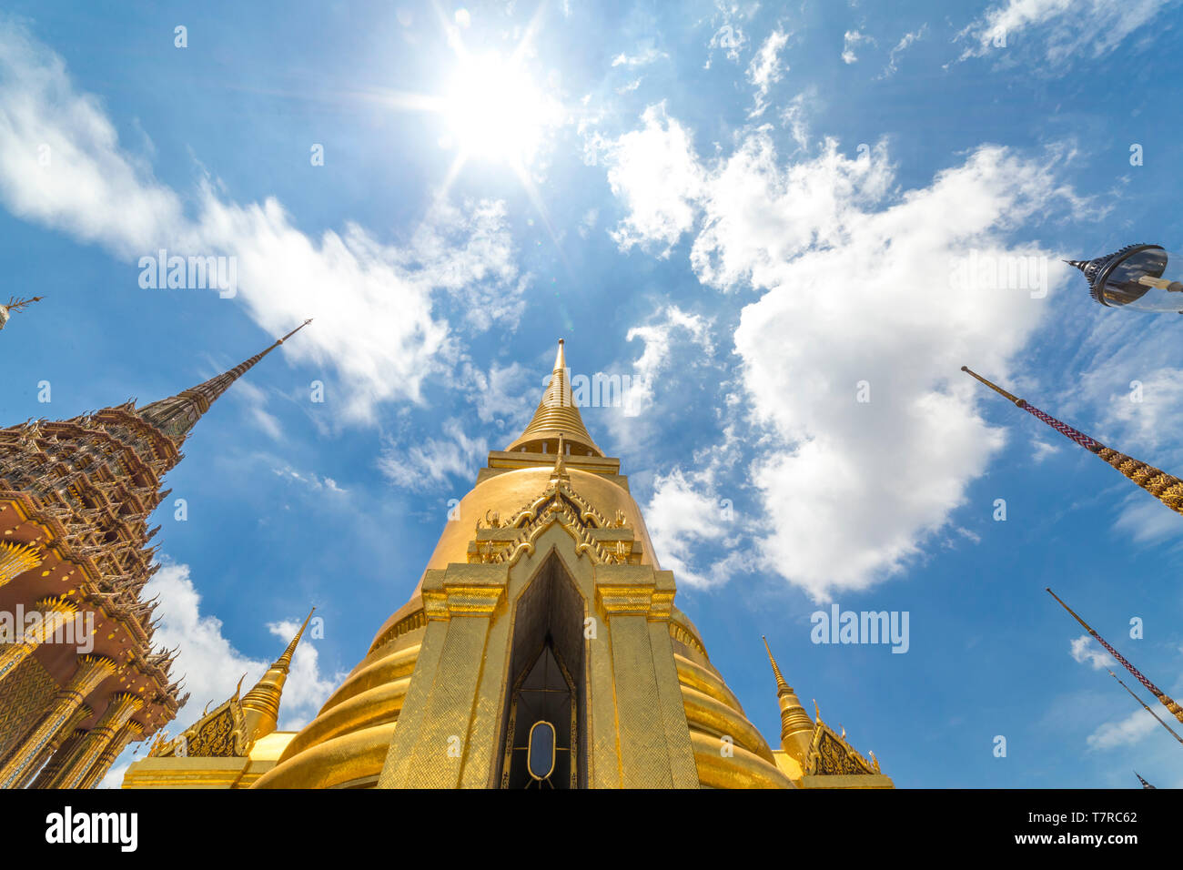 Magnifico stupa dorato verso il cielo blu e nuvole nel Grand Palace e il Tempio del Buddha di Smeraldo di Bangkok, Tailandia Foto Stock