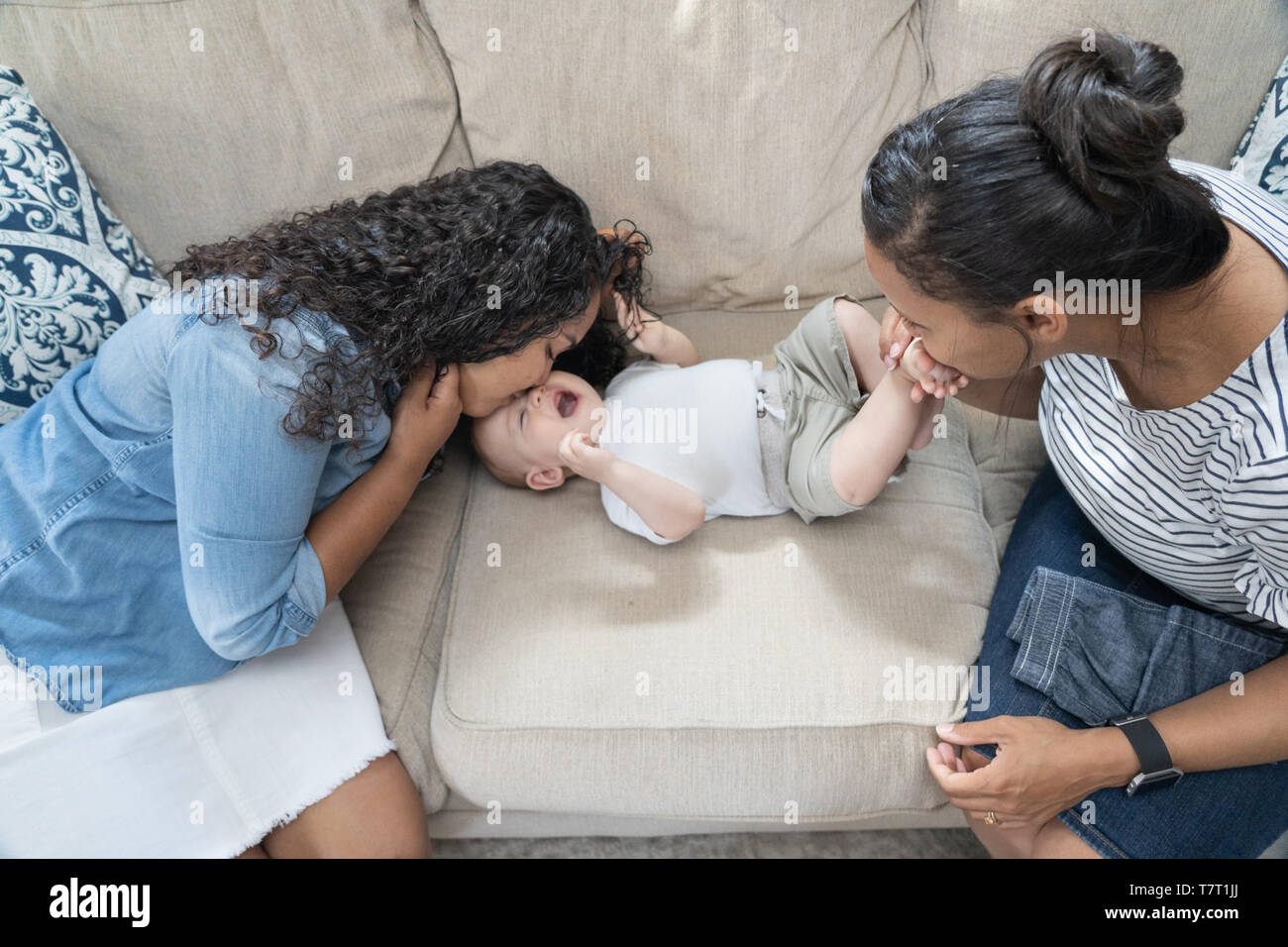 La madre gioca con il suo bambino con sua figlia di quindici anni nella loro casa nel nord di Philadelphia Foto Stock
