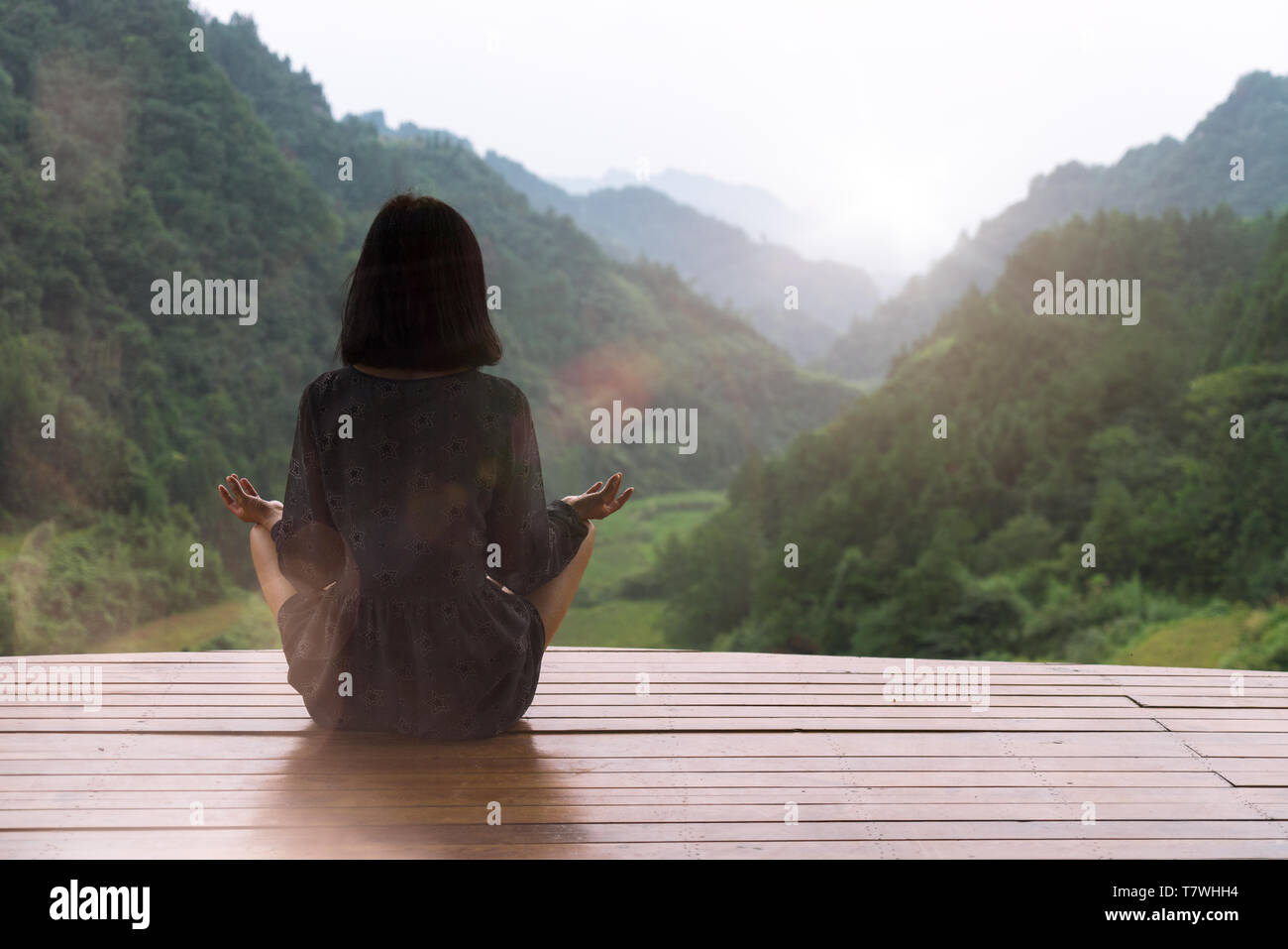 Giovane donna a praticare lo Yoga al tramonto Foto Stock