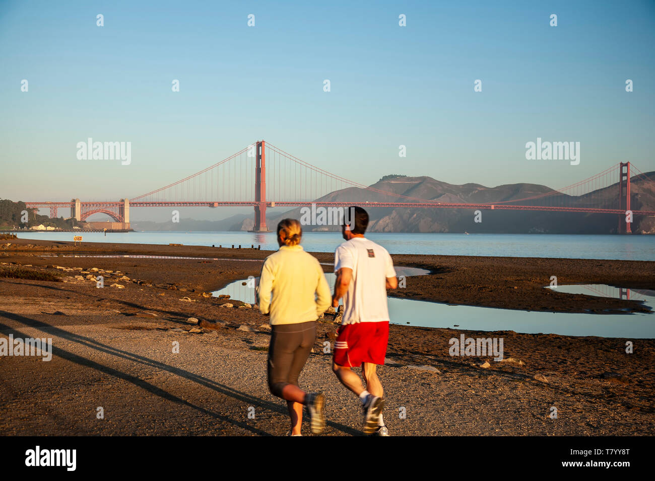 Esecuzione di coppia (su Crissy Field) e il Golden Gate Bridge di San Francisco, California USA Foto Stock
