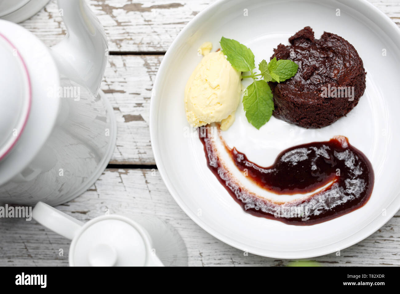 , Gustosi dessert e dolci, gelati e frutta su una piastra bianca. Composizione orizzontale Foto Stock