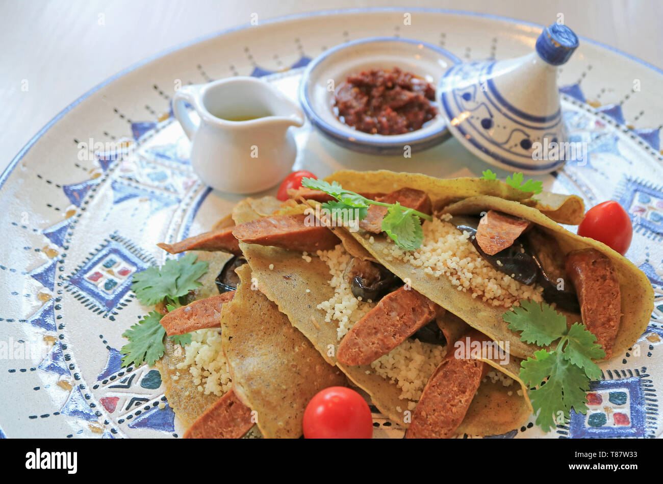 Stile marocchino crepes di grano saraceno con couscous marocchino, salsiccia e verdura Foto Stock