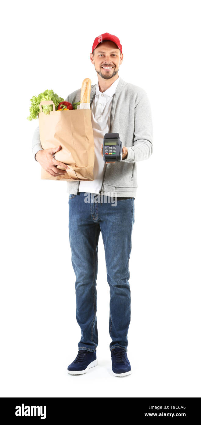 Uomo con sacchetto di carta con prodotti freschi e la banca di terminale su sfondo bianco. Il cibo del servizio di consegna Foto Stock