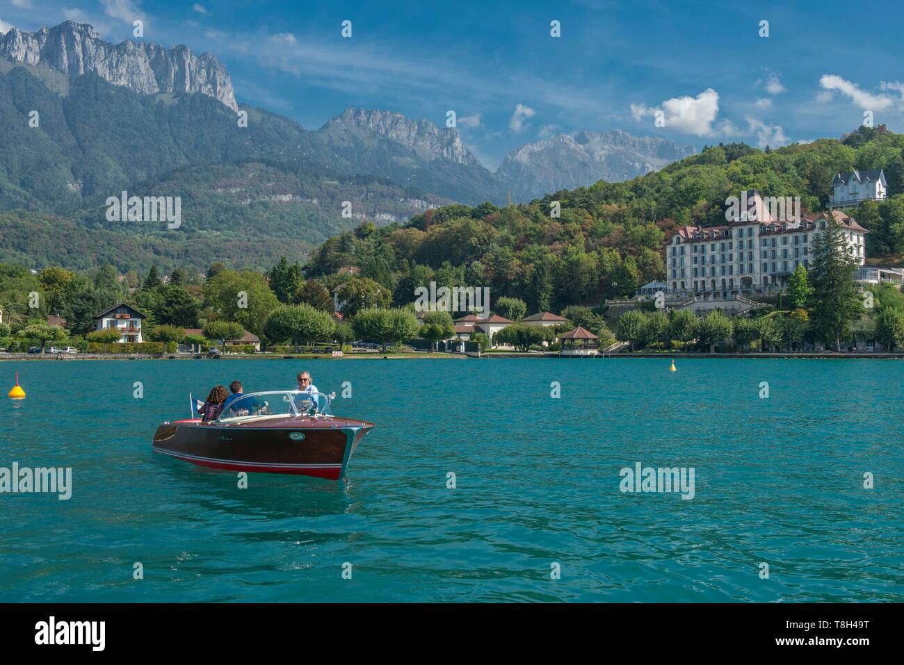 Francia, Haute Savoie, Annecy, passeggiata sul lago in barca Riva collezione con il villaggio e il palazzo di Menthon Saint Bernard e i denti di Lanfon Foto Stock