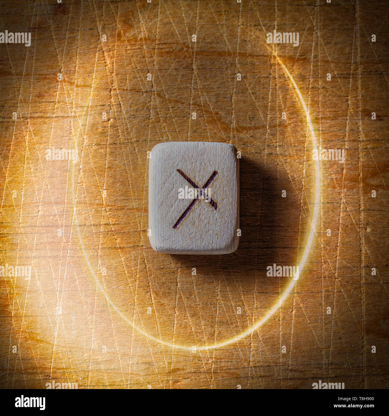 Nauthiz. Fatte a mano in legno scandinavo rune su una tavola di legno vintage sfondo in un cerchio di luce. Concetto di fortune raccontando e la previsione di Foto Stock