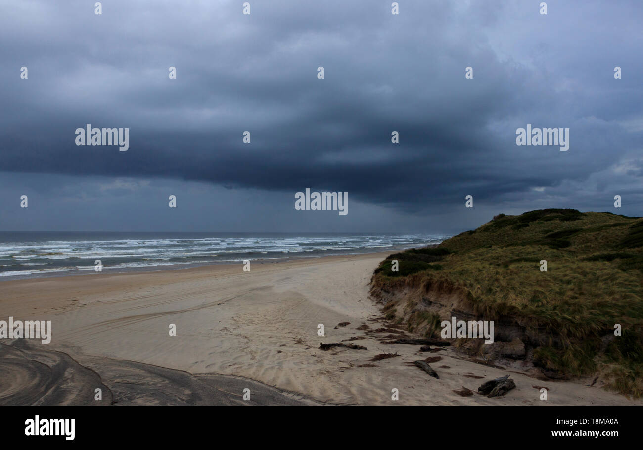 Nuvole temporalesche su Ocean Beach a nord di Hells Gates entrata di Macquarie Harbour sulla costa occidentale della Tasmania Australian vicino Strahan. Foto Stock
