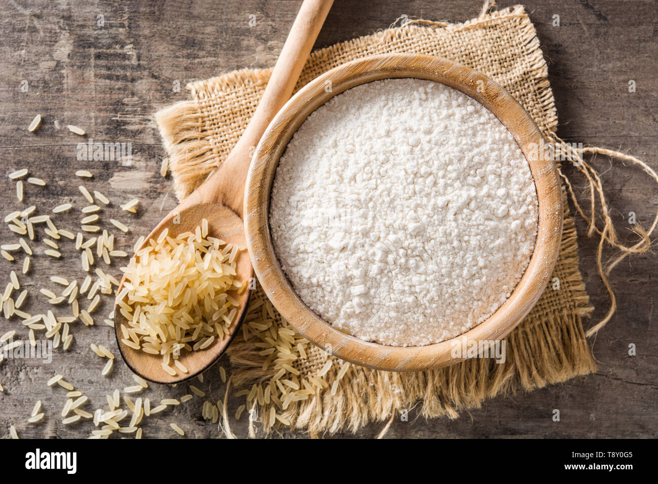 Farina di riso bianca in una ciotola sul tavolo di legno. Vista superiore Foto Stock