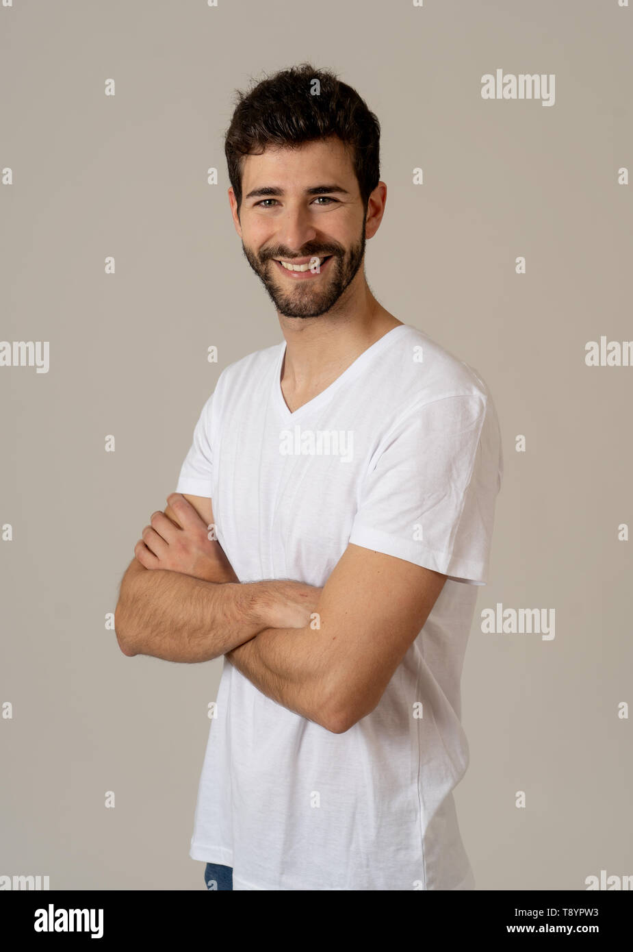 Ritratto di giovane uomo attraente con la barba occhi blu e uno splendido sorriso. Millenario modello hipster fiduciosi in posa e modellizzazione contro neut Foto Stock