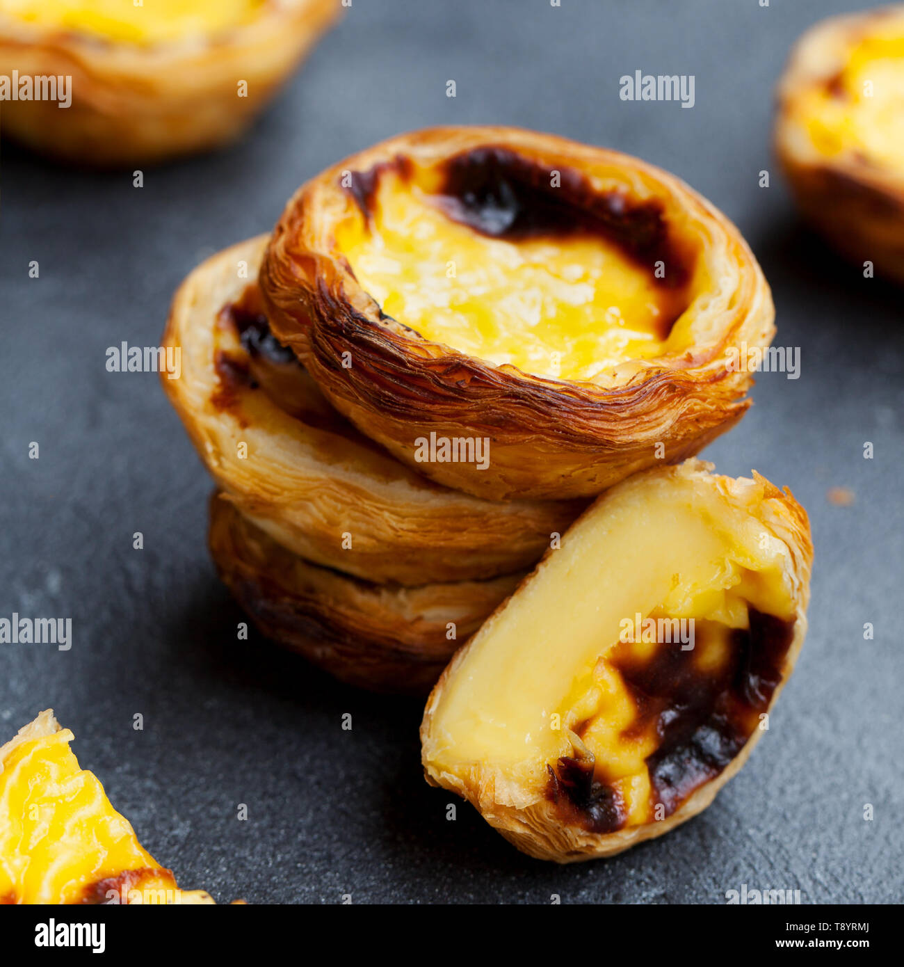 Uovo tart, tradizionale dolce portoghese, Pastel de nata, pasteis. Sfondo di ardesia. Close up. Foto Stock