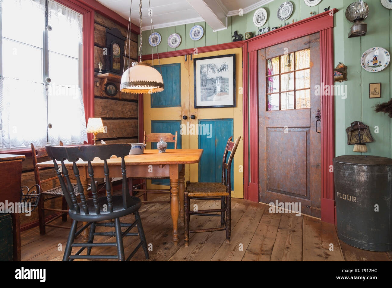 Pineta tavolo da pranzo con sedie assortiti in cucina con indossato vasta  pineta plank tavoloni all'interno di un vecchio 1835 Canadiana cottage in  stile casa, Québec, Canada. Questa immagine è di proprietà