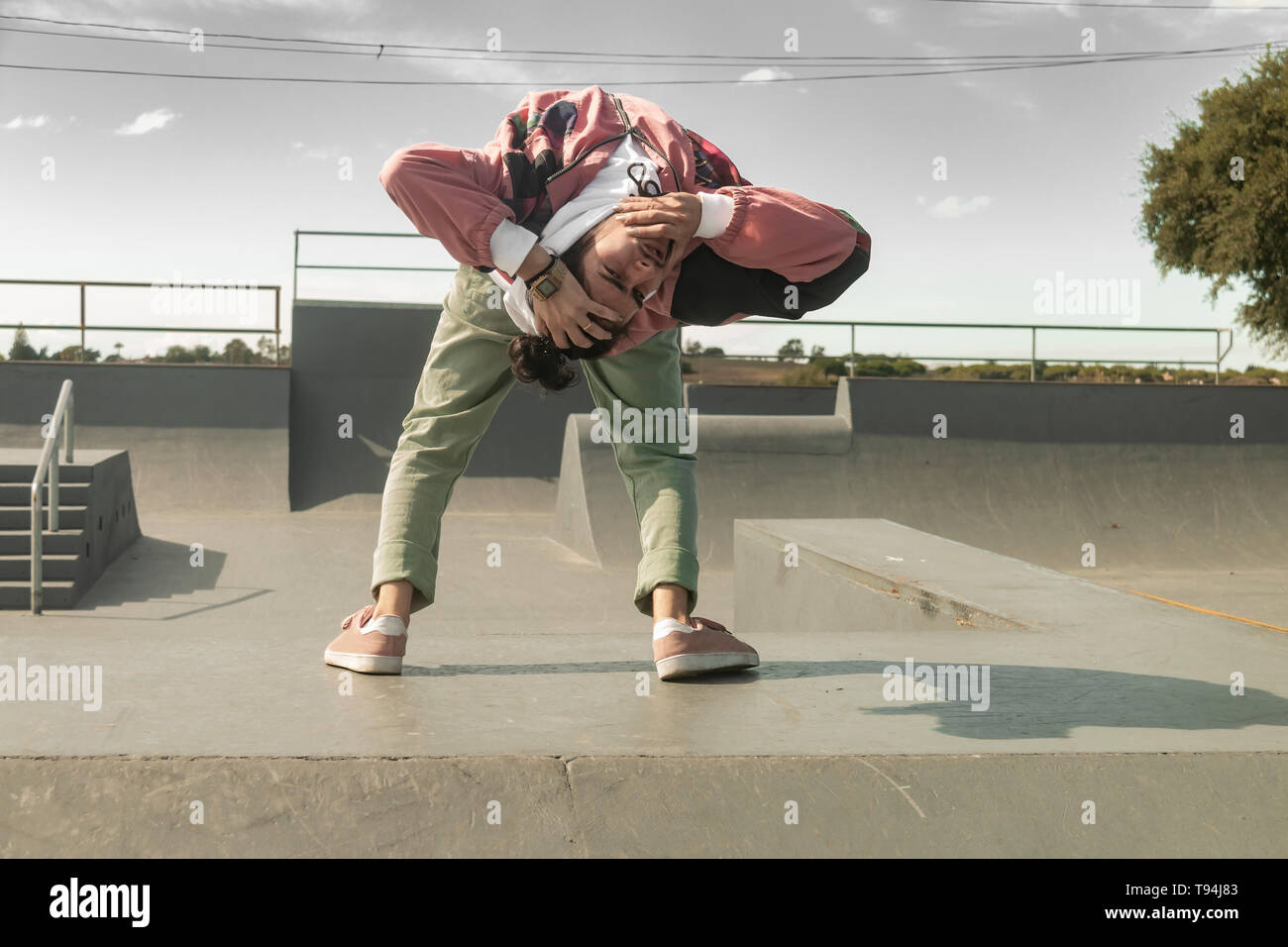 Giovane ballerina bianca danza hip-hop freestyle in uno skate park Foto Stock
