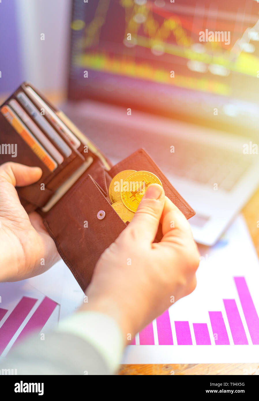 Mettendo mano virtuale bitcoins dorata in portafoglio Foto Stock