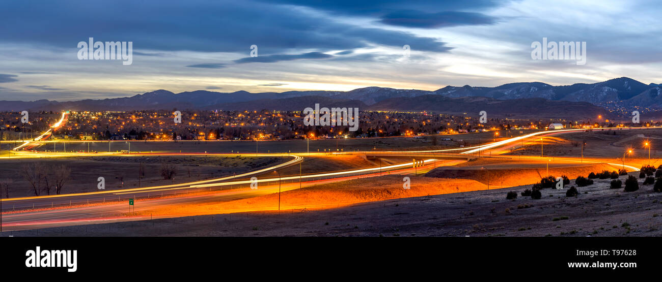 Sunset Highway - un panorama al tramonto di U.S. Autostrada 285 avvolgimento a foothill del Front Range delle Montagne Rocciose su un burrascoso sera d'inverno. Denver, CO, Stati Uniti d'America. Foto Stock