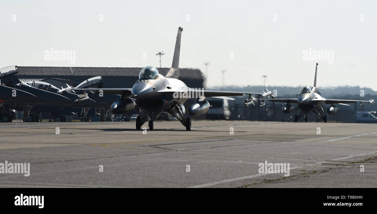 Un F-16C Fighting Falcon assegnato alla 93Fighter Squadron, Homestead Air Base di riserva, Fla., taxi passato F-15E Strike Eagles durante una formazione di volo distribuzione presso la Royal Air Force Lakenheath, Inghilterra, 16 maggio 2019. Il fuoco primario del FTD è per la Reserve Squadron per integrare con gli Stati Uniti Forze Aeree in forze Europe-Air Africa e Royal Air Force di unità di base condotta Fighter manovre e dissimile Air Combat Training. (U.S. Air Force foto di Airman 1. Classe Madeline Herzog) Foto Stock
