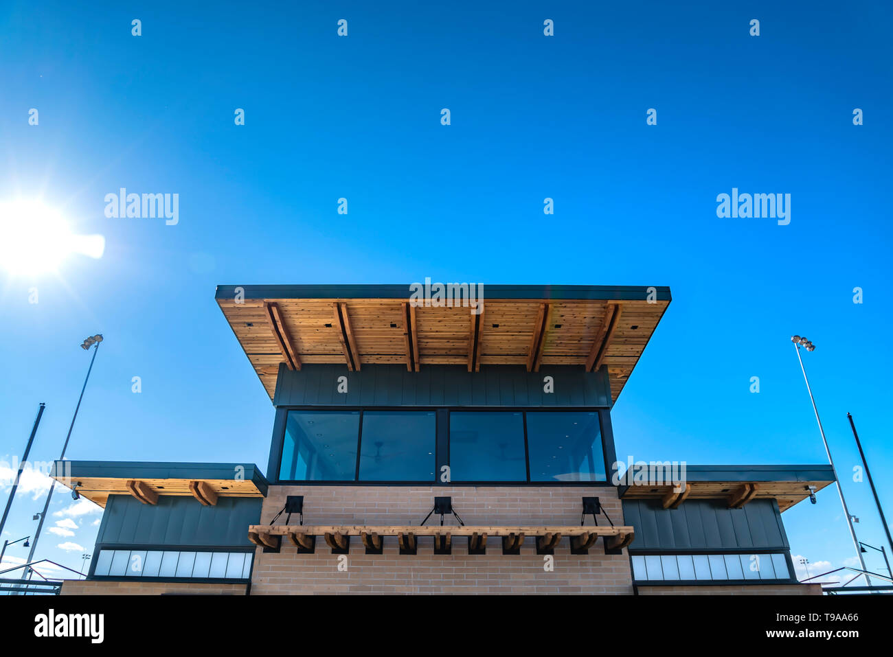 Esterno di un edificio in mattoni rossi con tetto piatto ed enormi finestre di vetro Foto Stock