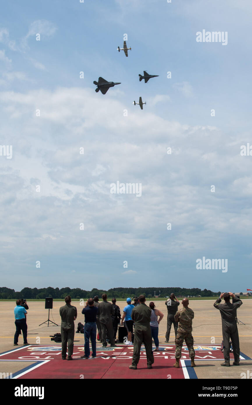 Spettatori guarda come Stati Uniti Air Force Il Mag. Garret Schmitz, F-16 Viper team di dimostrazione e il comandante pilota, U.S. AIr Force Il Mag. Paolo Lopez, F-22 Raptor dimostrazione pilota del team, Jim Beasley e Andrew Mckenna, Air Force del patrimonio della fondazione di volo P-51 piloti volare in un 4-nave volo patrimonio syllabus sortie a base comune Langley-Eustis, Virginia, 17 maggio 2019. Il combattimento aereo il comando i piloti devono completare una formazione rigorosa e ricevere la certificazione da parte di quattro livelli di Forza aerea degli Stati Uniti prima di leadership possono guadagnare il titolo di team di dimostrazione Commander. (U.S. Air Force Foto di Senior Airma Foto Stock