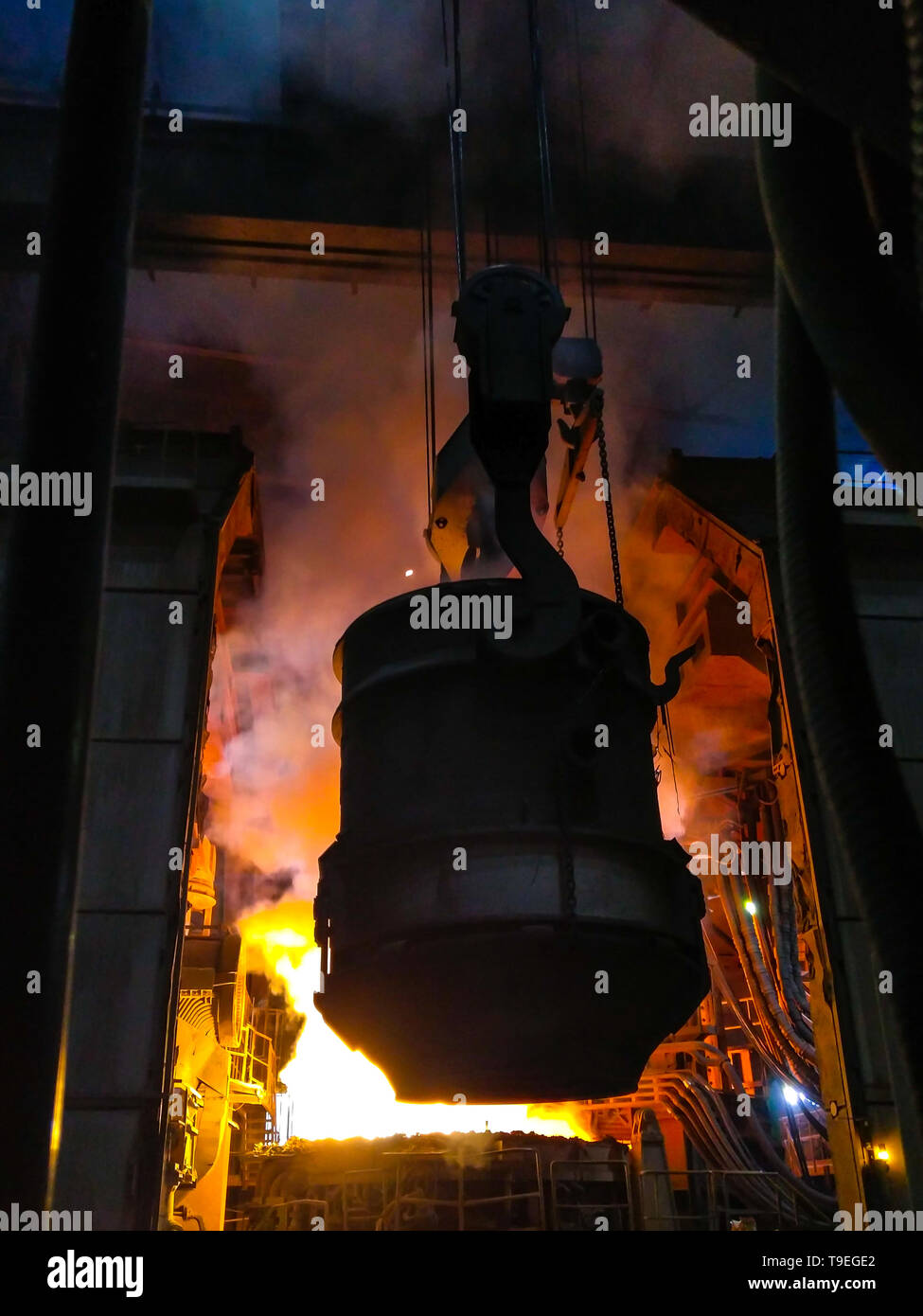 Fusione del metallo nella grande fonderia. Produzione di ferro e acciaio in un impianto metallurgico. Lavoratore di acciaio. Processo di metallurgia. Foto Stock