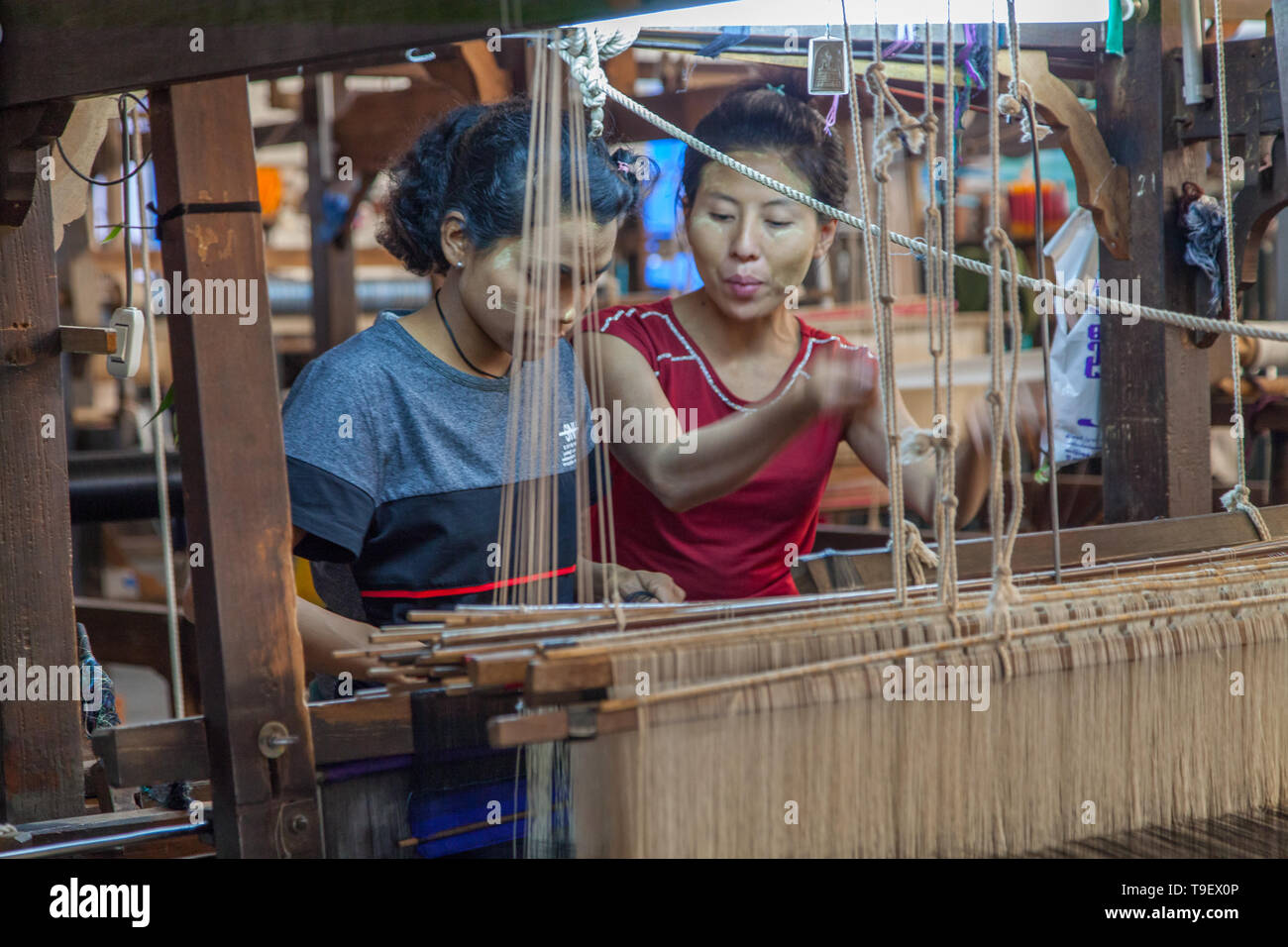 Giovani donne birmane lavorando al telaio Foto Stock