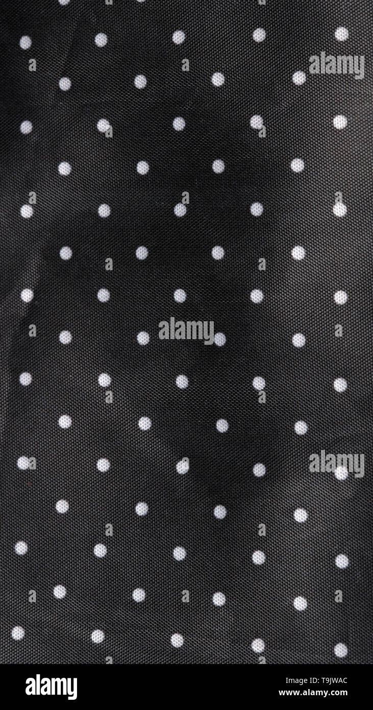 Tessuto nero lo sfondo con puntini bianchi Foto Stock