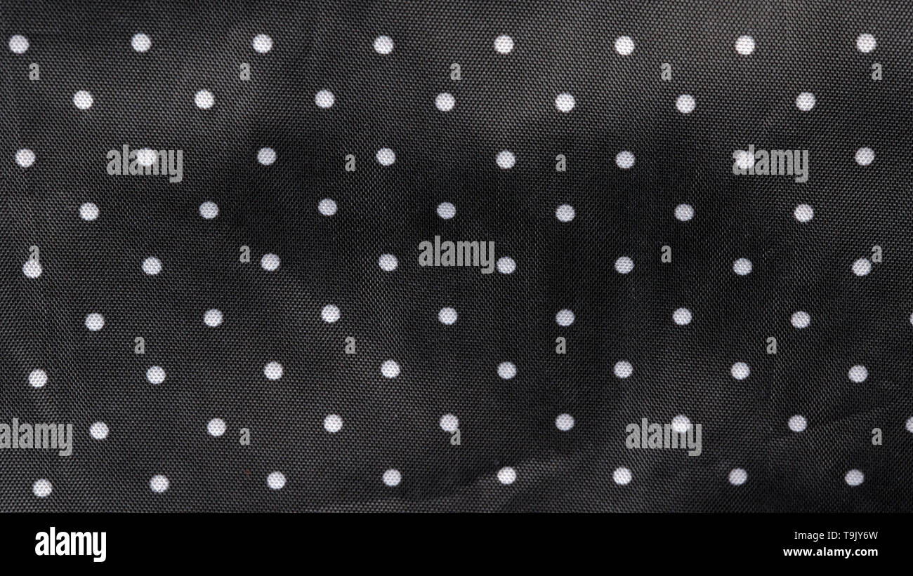 Tessuto nero lo sfondo con puntini bianchi Foto Stock