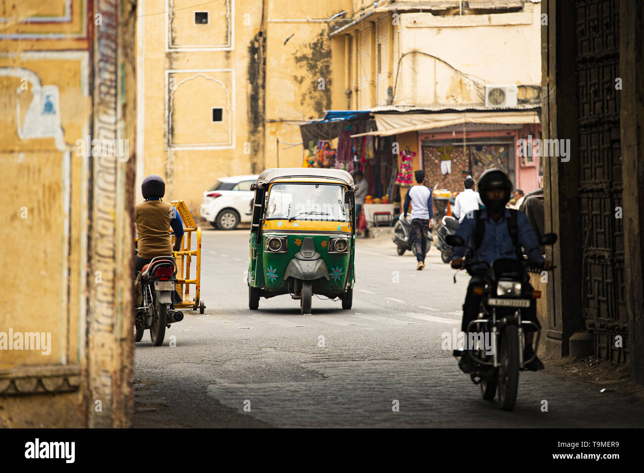 La vita della città con Auto rickshaw (noto anche come tuc tuc) e moto attraverso le strade di Jaipur. Foto Stock