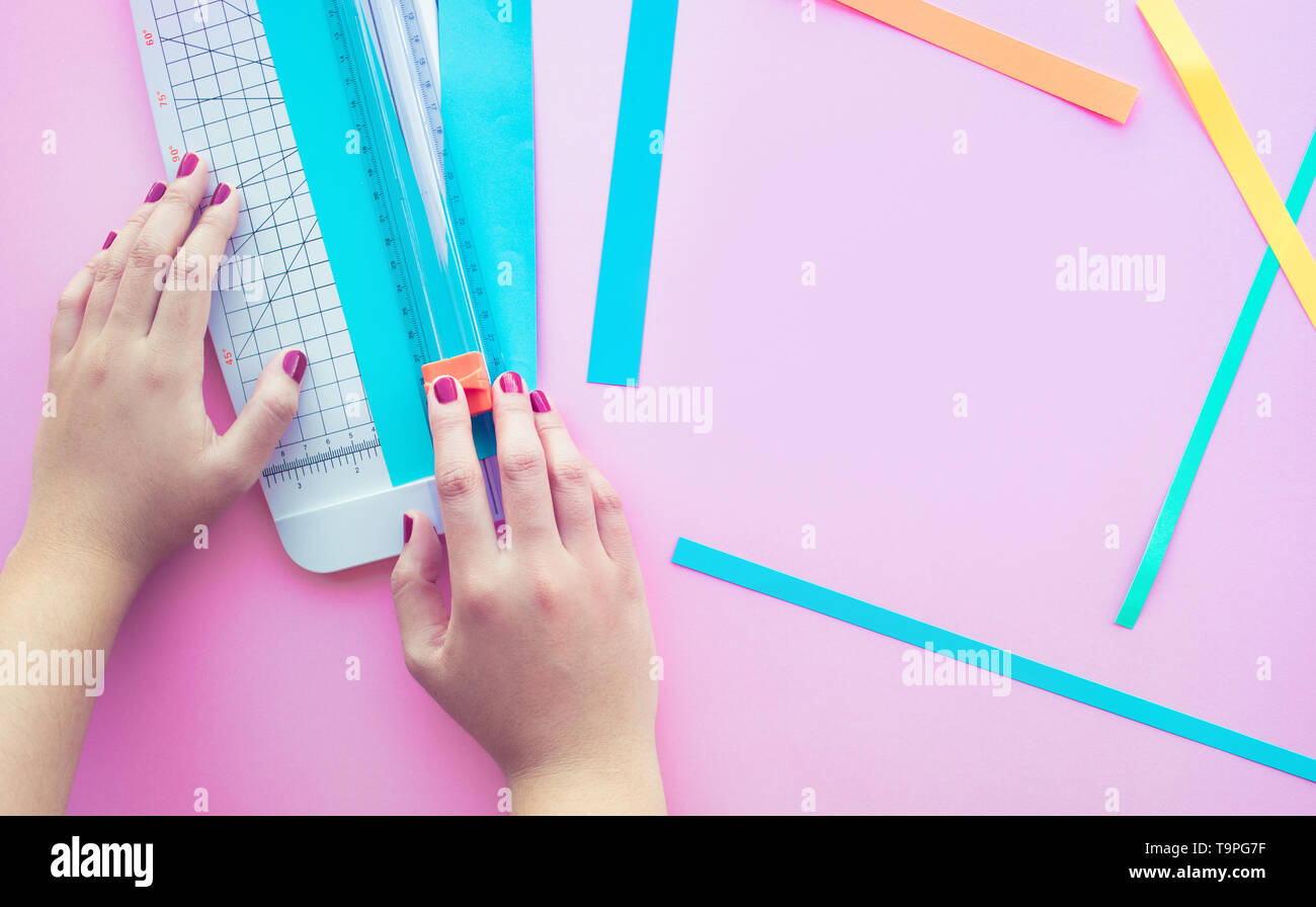 Giovane donna fare arte di carta colorata di rosa di sfondo spazio.Hobby decorazione design Foto Stock
