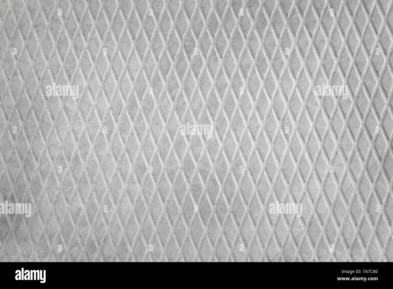 Grigio ruvida soletta in calcestruzzo con struttura a diamante vicino. Tessitura industriale e lo sfondo Foto Stock